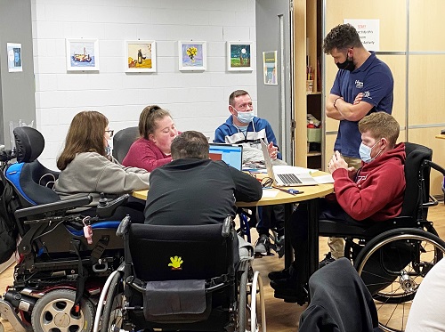 Wheelchair users interact with a researcher